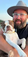 A picture of Tim holding his dog
